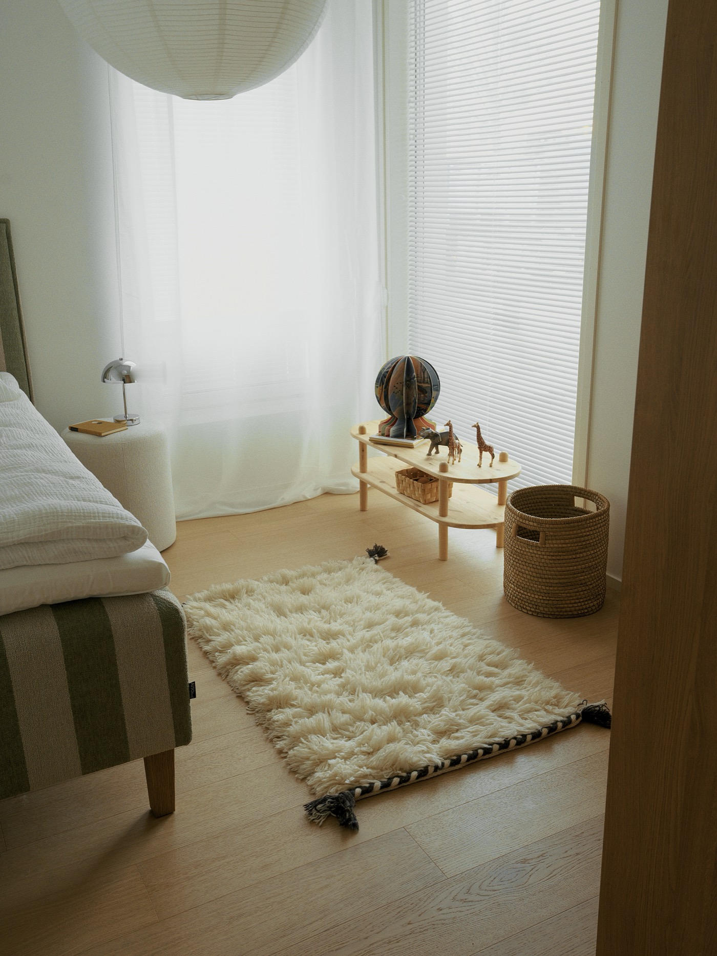 A child’s room in Grand, window light glowing through the curtains